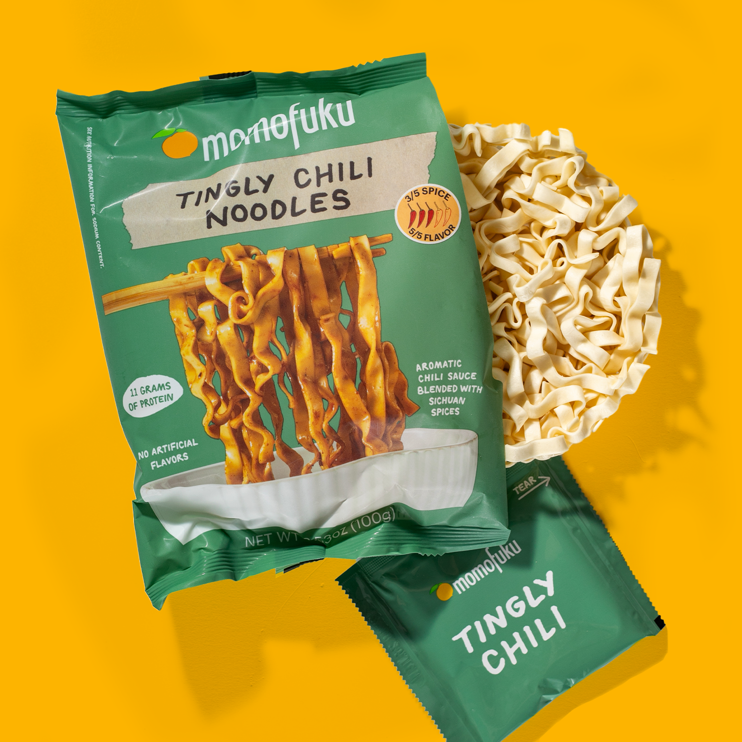 Moenofuku Tingly Chili Noodles packaging on a yellow background